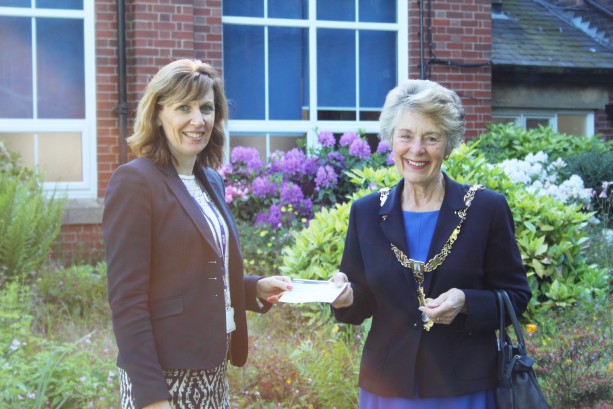 Head Teacher, Sarah Burns receiving the cheque from Mayor Merry